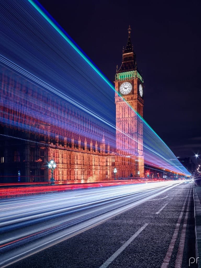 Elizabeth Tower and the Palace of Westminster at night, with traffic light trails.